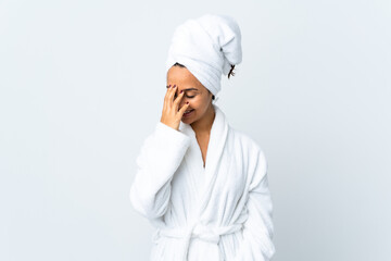 Young woman in bathrobe over isolated white background laughing