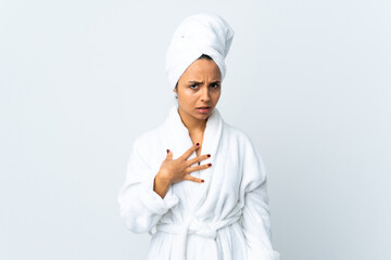 Young woman in bathrobe over isolated white background pointing to oneself