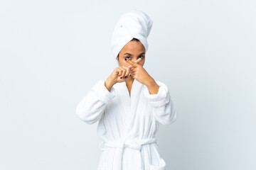 Young woman in bathrobe over isolated white background making stop gesture with her hand to stop an act
