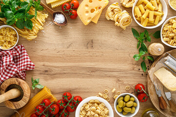 Italian food. Culinary concept background with ingredients for cooking on wooden kitchen rustic table, top view with copy space. Ingredients for cooking pasta.