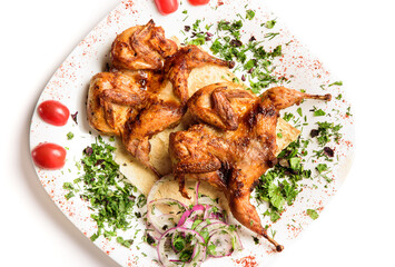 Grilled quails on a white plate. Fried chicken. Partridge barbecue.