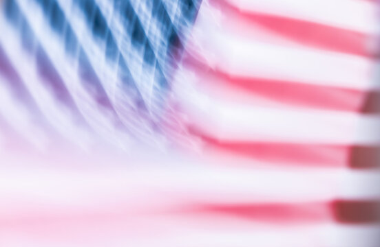 Abstract blurry American flag background. Colorful element with patterns and stripes. Dynamic, fast movement, energy concept. Artistic gradient multicolor of blurred geometric seamless wallpaper.