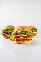 three differents burgers, white background, white reflection