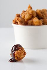 chicken pop corn with sauce, withe bucket bowl. white background 