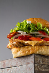 chicken hamburger over a steal table, grey background
