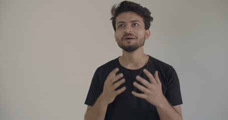 Closeup shot of a young Indian guy explaining
