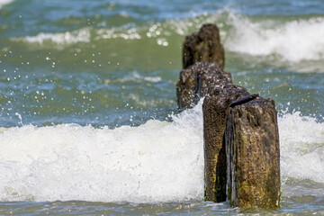 Landscapes of Poland. Breakwater  at Baltic sea. Wavy water.