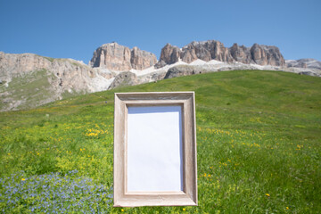 Empty wooden picture frame mockup in sunlight with mountains in the background. Summer vacation in the mountains. Template for articles and equipment for the mountain. Advertising for natural products