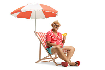 Mature male tourist sitting in a chair with a cocktail under umbrella © Ljupco Smokovski