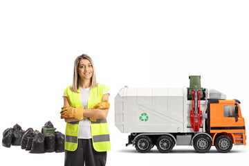 Female waste collector in a uniform with a garbage truck