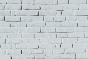 The brick wall is painted with white paint. Textured background of the facade of the old factory. Uneven tinted worn plaster. Design element. Abstract Light White Web Banner. Copy space