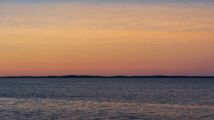 Glowing sky at sunset, over the bay