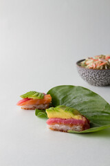 sushi pizza with blue background, leaf plate with neptune salad
