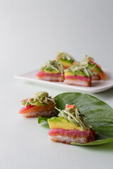 sushi pizza with blue background, leaf plate with neptune salad