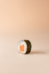 Sushi salmon roll, brown background, isolated