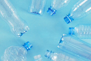 several plastic bottles on blue background. zero waste, pollution of nature, eco friendly concept.