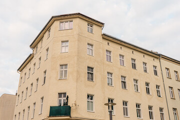 Fototapeta na wymiar yellow apartment corner building at weissensee, berlin