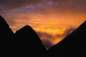 An orange sunset over volcanos in northern Ecuador