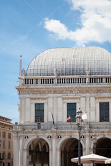Fototapeta premium The Palazzo della Loggia is a renaissance square with a city hall (Comune di Brescia) surrounded by Venetian-style buildings located in the town in Lombardy, Italy. Historical European landmark.