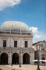 Naklejka premium The Palazzo della Loggia is a renaissance square with a city hall (Comune di Brescia) surrounded by Venetian-style buildings located in the town in Lombardy, Italy. Historical European landmark.