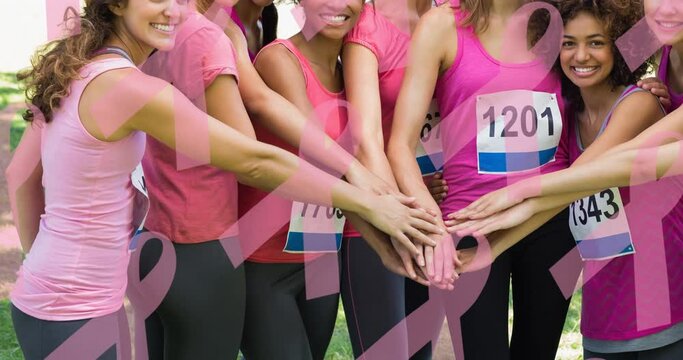 Animation of multiple pink ribbon logo over diverse group of smiling women