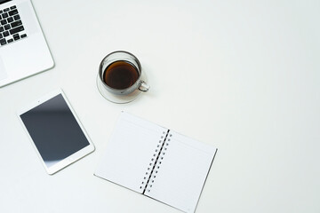 workspace with tablet, note and cup of coffee