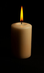 Fototapeta na wymiar Big flame in a candle in the dark