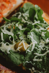 foreground cpm olive and rucula pizza with cheese