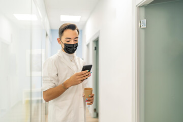 doctor consulting their smartphone on their break