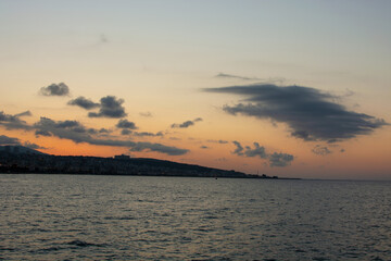 Beautiful nightly seascape with lighthouse and moody sky at the sunset.