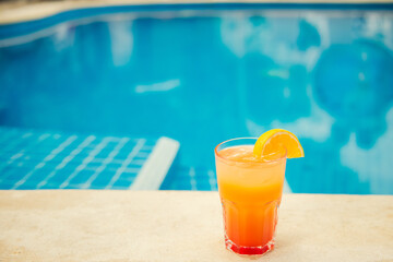 Colorful tropical cocktails on wooden bar. Mixology in pool holiday