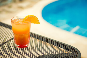 Colorful tropical cocktails on wooden bar. Mixology in pool holiday
