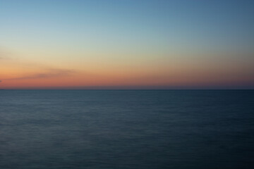 Naklejka na ściany i meble long exposure sea and sky at sunset.