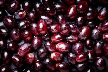 Background from red grapes covered with water drops.