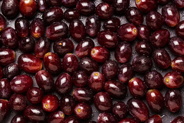 Background from red grapes covered with water drops.