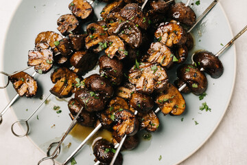 Overhead photo of grilled marinated Cremini mushroom skewers