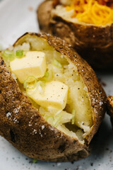 Baked potatoes with butter and green onions