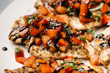 Bruschetta chicken breasts with balsamic reduction