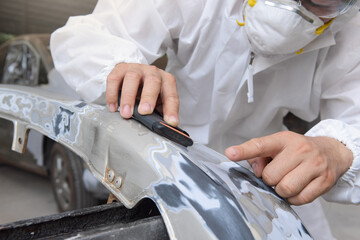 Man on a car wash polishing car with a polish machine