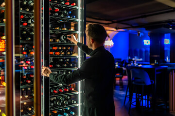 sommelier choosing a good wine for his clients