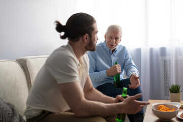 Grandfather and grandson speaking on couch