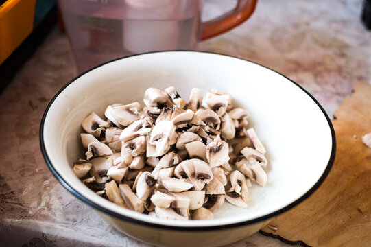A plate of chopped mushrooms on kitchen table