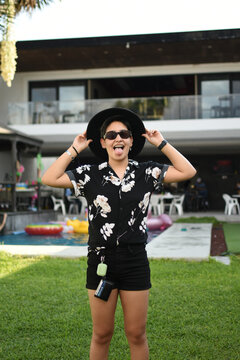 influential Girl with glasses and black outfit posing relax