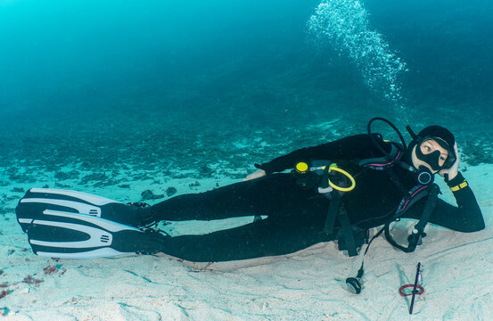 woman relaxing on ocean floor in Raja Ampat