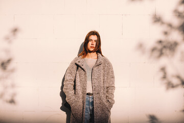 Portrait of transgender woman standing against wall in city