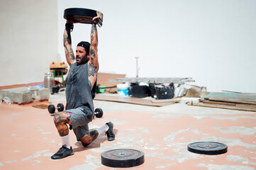 Fitness man lifting weights in outdoor gym. Bodybuilder doing deadlift workout