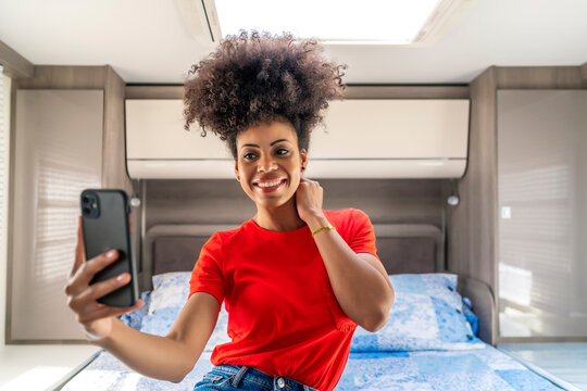 beautiful African woman taking a photo from her smartphone