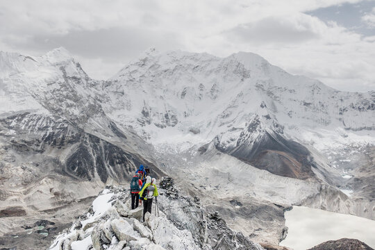 Team of alpinists traverses a rocky ridge on Island Peak
