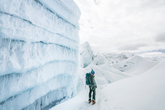 Climber next to an ice wall on Island Peak, Nepal