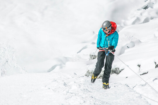 A young woman descends the Island Peak headwall near Everest in Nepal